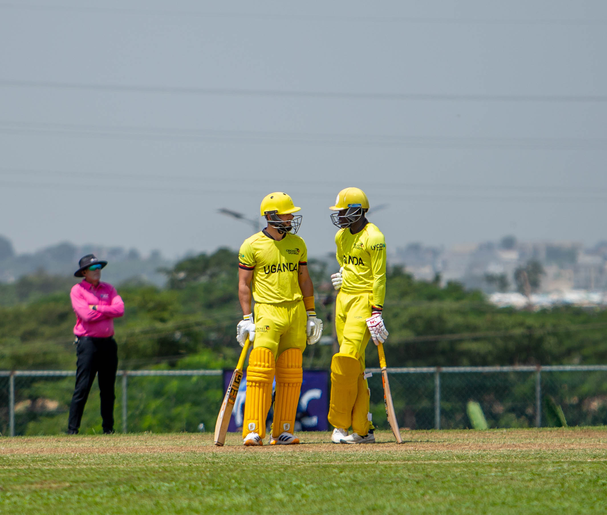 Tactical Huddle. Gerald Olipa (R) and captain Riazat Ali Shah discuss strategy during an over interval as the Cricket Cranes fine-tune their approach in search of a sharper all-round performance against Gambia in Abuja.